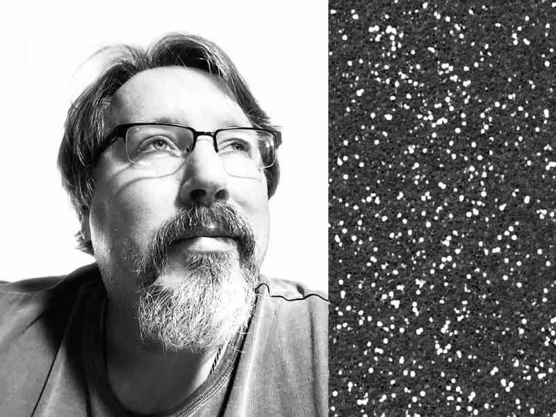 A middle aged white man, author Brian Turner, is pictured.