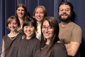 Six student soloists are pictured smiling at the camera. L to R: Grace Stringfellow, Josephine Barstad, Anne Yap I-Shyuen, Aria Beert, Karla Lugo, Luis Gomez.