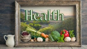 A picture frame with a nature landscape and fruits and vegetables with the word "Health" at the top