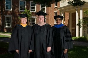 Faculty in front of a building