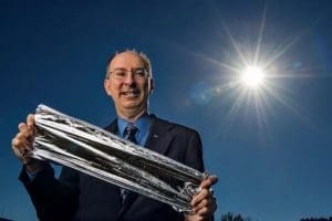 Les Johnson holding a piece of solar sail