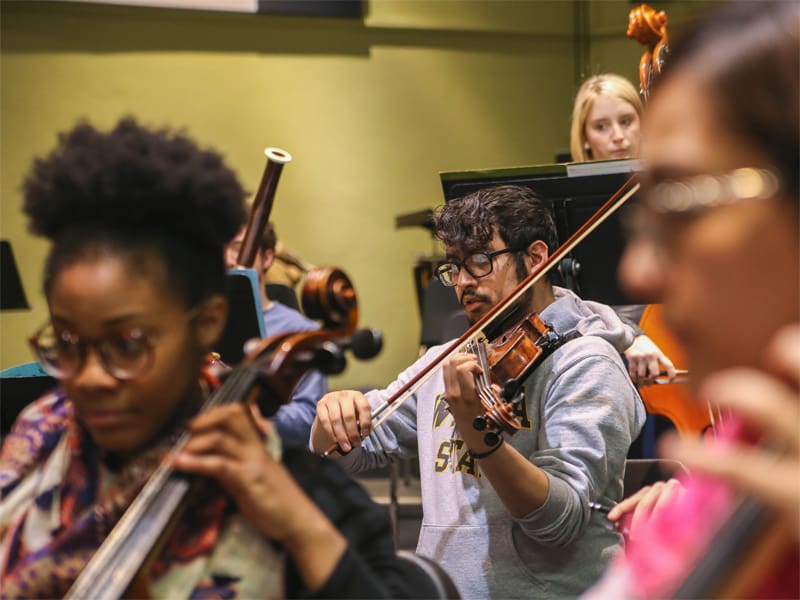 Students participating in band practice, playing various instruments
