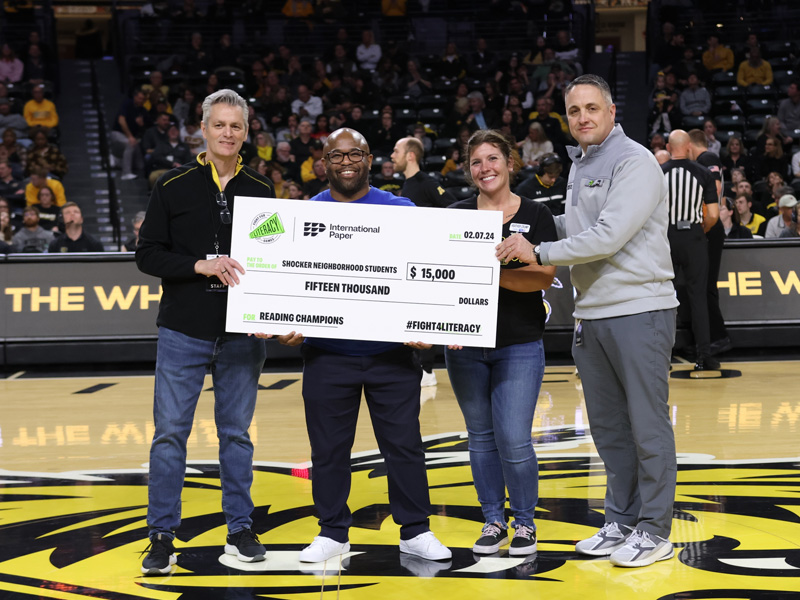 President Rick Muma, Kevin Saal and members of United Way present the money raised for the United Way Champions for Literacy 2024 campaign