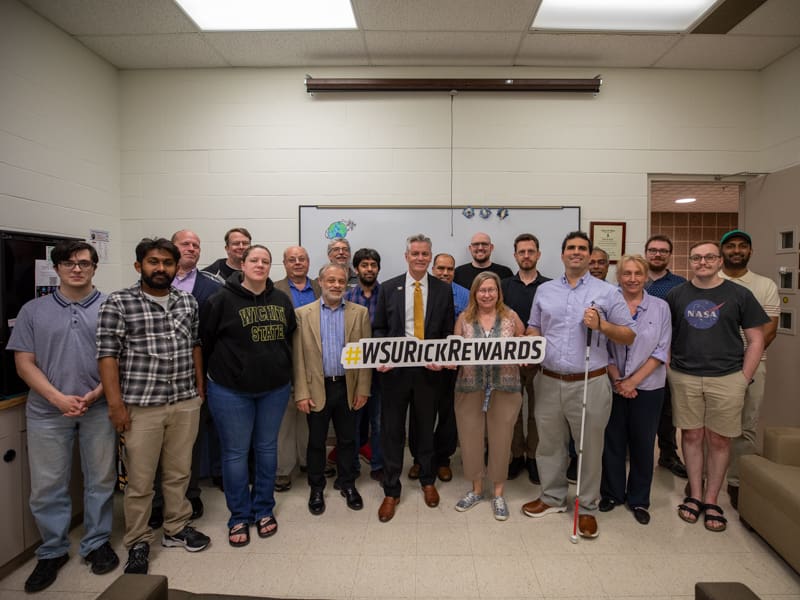 President Rick Muma poses with the WSU physics department for Rick Rewards