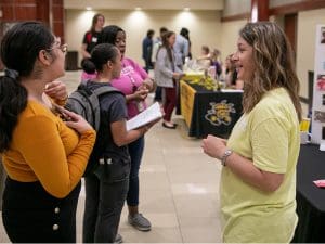 Photo of people interacting at career fair.