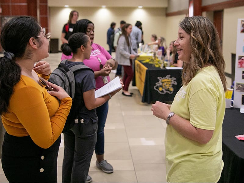 Photo of people interacting at career fair.