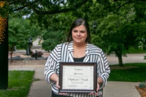 Portrait of Stephanie holding her award