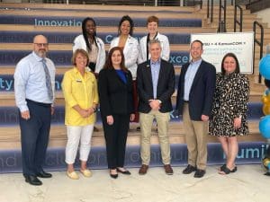 Officials from Wichita State University and the Kansas Health Science Center-Kansas College of Osteopathic Medicine post after signing the partnership