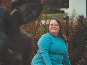 Lilith Samples next to the Mother and Child statue by Charles Grafly on campus
