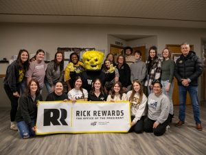 President Rick Muma and WuShock post with the staff of the Child Development Center Jan. 17 for Rick Rewards