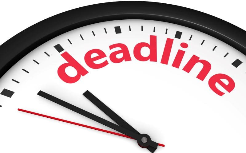 clock face with "deadline" written on face of clock