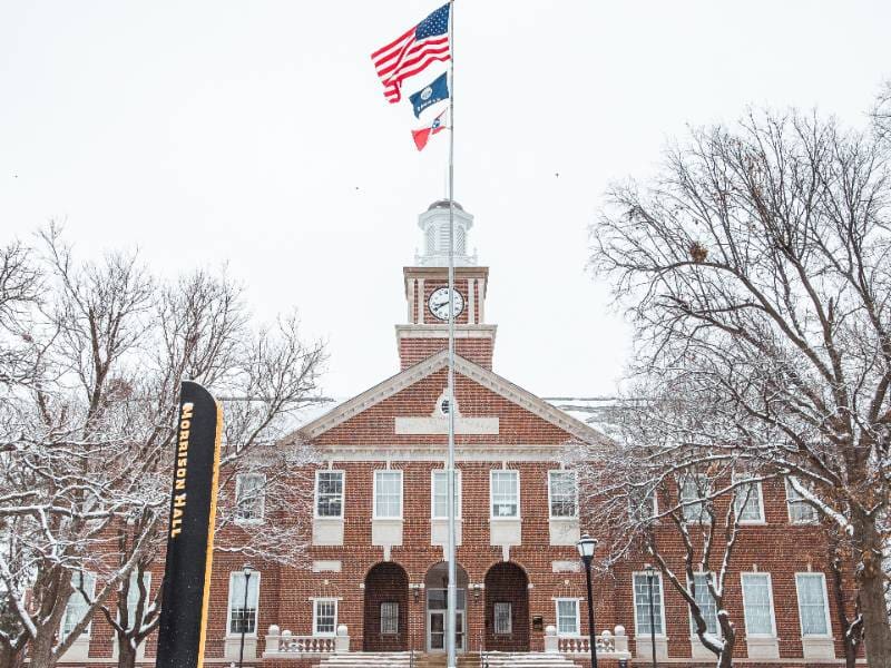 Morrison Hall on campus covered in snow.
