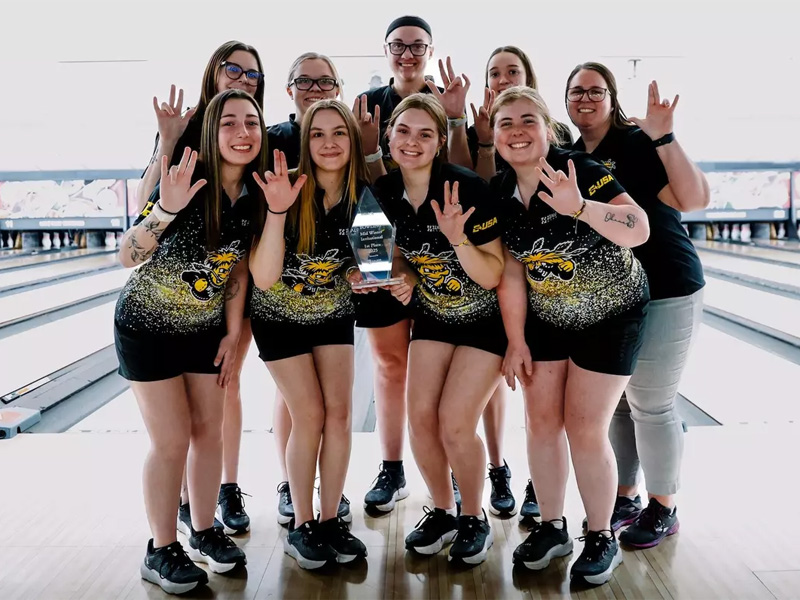 Shocker women's bowling team holds up their trophy from the Mid-Winter Invitational