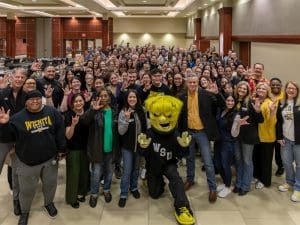 Employees at Wichita State pose with President Rick Muma and WuShock for Employee Appreciation Day
