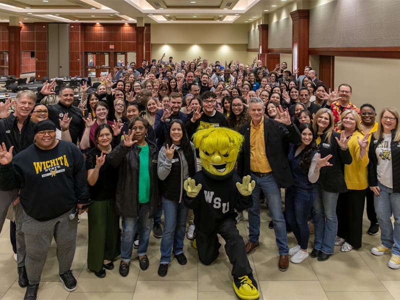 Employees at Wichita State pose with President Rick Muma and WuShock for Employee Appreciation Day