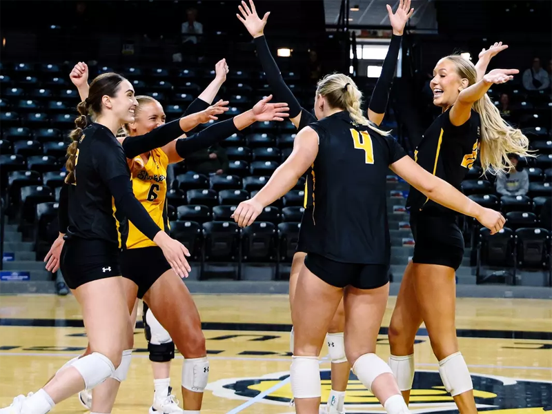 The Shocker volleyball team celebrate after winning a game in Charles Koch Arena