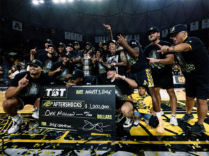 The AfterShocks team poses with its $1 million check after winning The Basketball Tournament in Charles Koch Arena