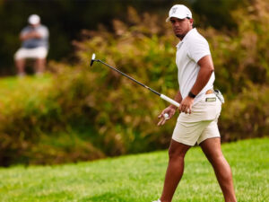 Jose Miguel Ramirez picks up a golf ball after a successful round