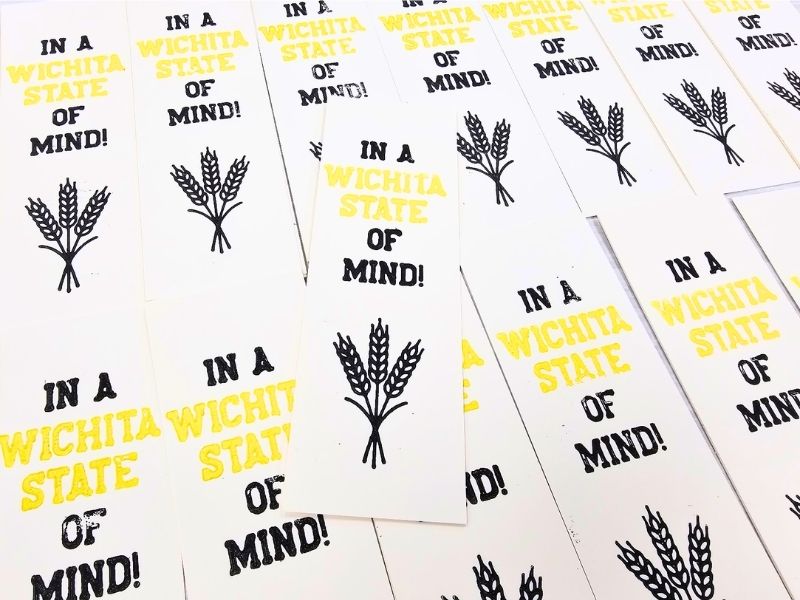 array of letterpress bookmarks that say "In a Wichita State of Mind" with a shock of wheat