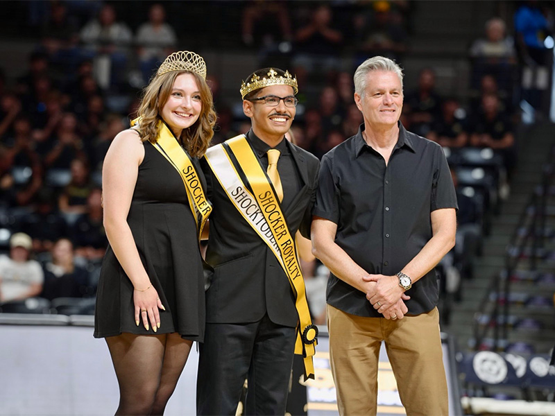 The Shocktoberfest Court pose with President Rick Muma in Charles Koch Arena